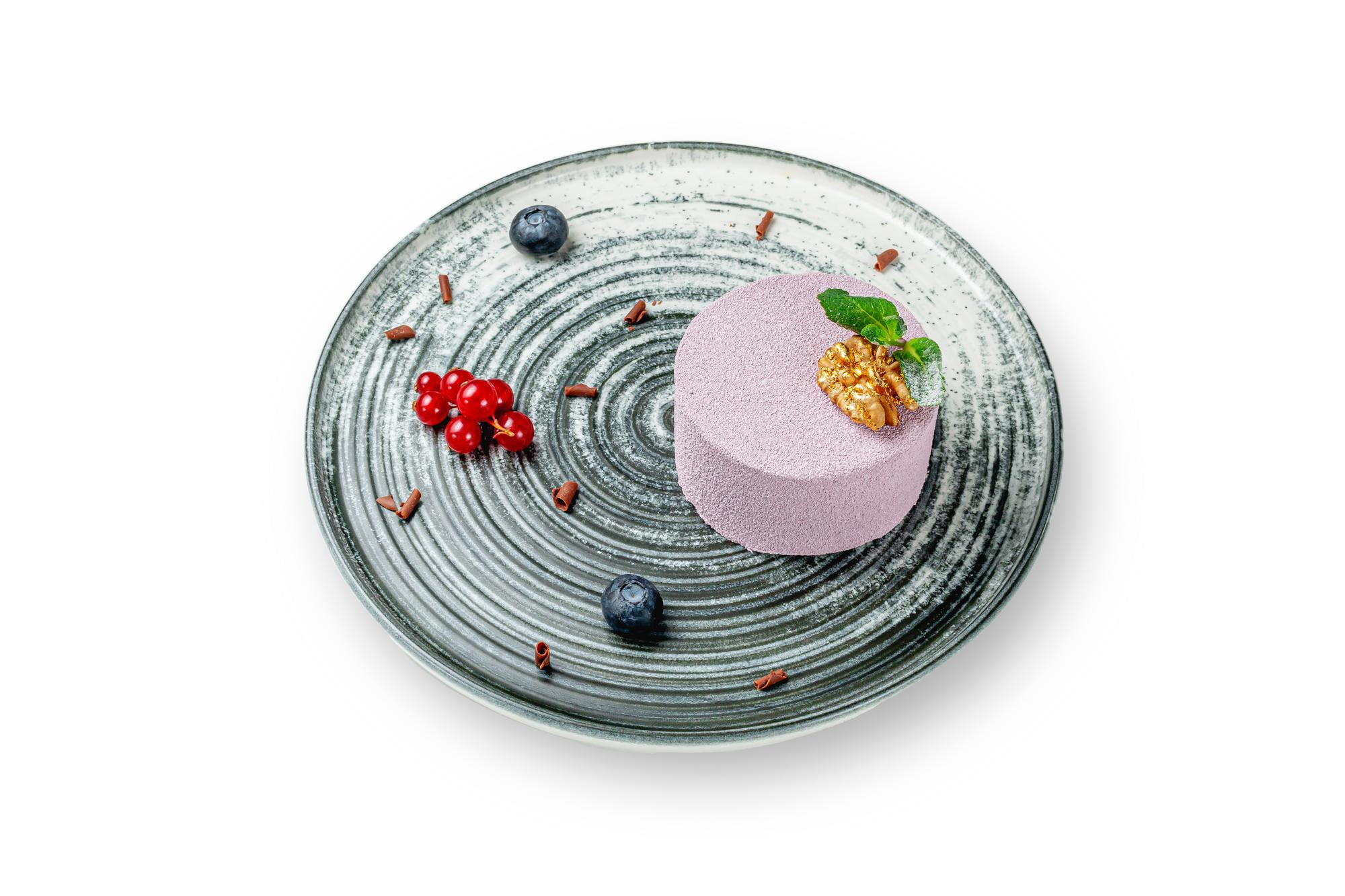 Chef with futuristic kitchen tools arranging a plated dish
